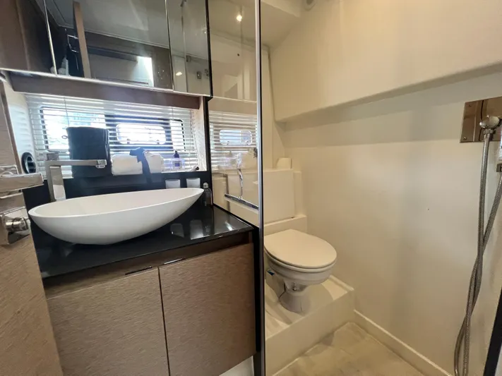  Yacht Photos Pics Luxurious bathroom in a 2018 Prestige 460 yacht, featuring modern sink and toilet.