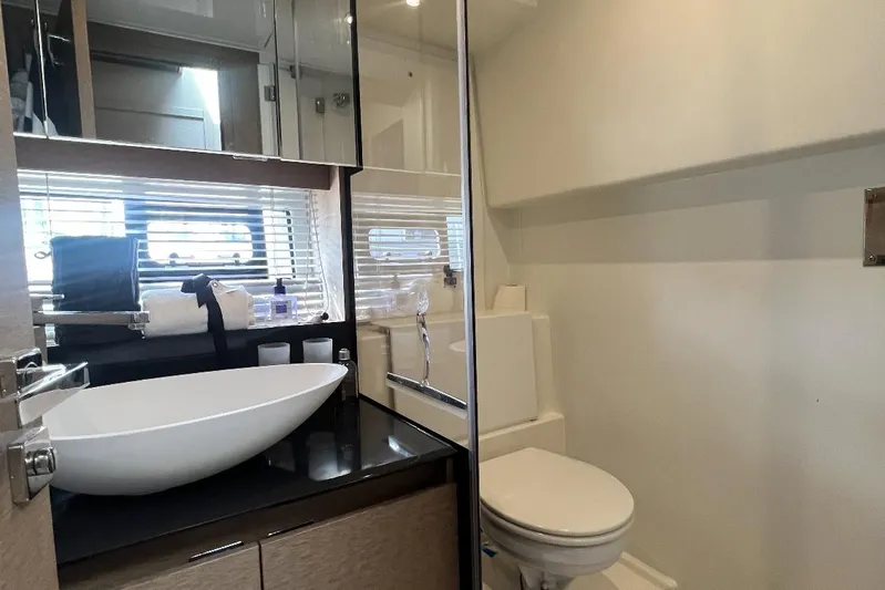  Yacht Photos Pics Modern bathroom interior of 2018 Prestige 460 yacht with sleek sink and toilet.