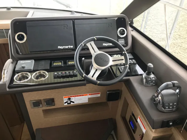  Yacht Photos Pics Cockpit of 2018 Prestige 460 yacht with Raymarine navigation system and modern controls.