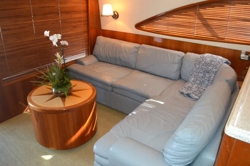 Quite Nice Yacht Photos Pics Luxurious interior of 2004 Bertram 570 Convertible yacht with plush seating and elegant decor.