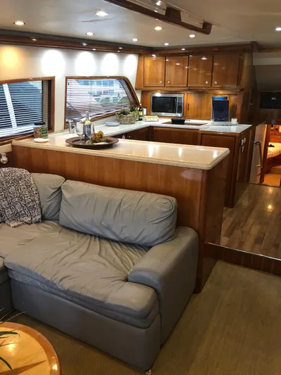 Quite Nice Yacht Photos Pics Luxurious interior of a 2004 Bertram 570 Convertible yacht with modern kitchen and seating area.