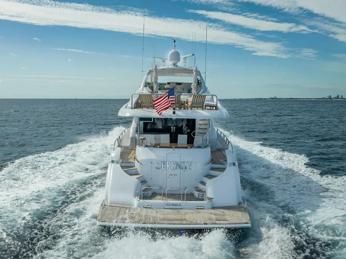Serenity Yacht Photos Pics 2008 Lazzara Motor Yacht cruising on open water with American flag.