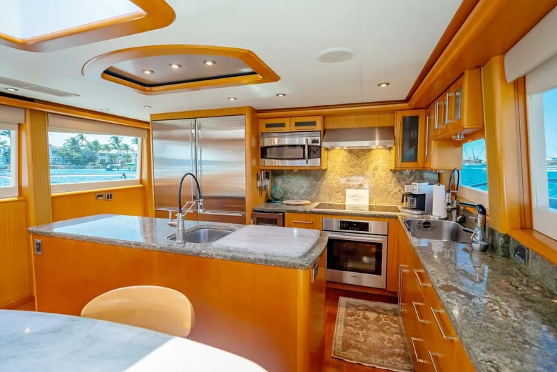 Serenity Yacht Photos Pics Luxurious kitchen in a 2008 Lazzara Motor Yacht with modern appliances and granite countertops.