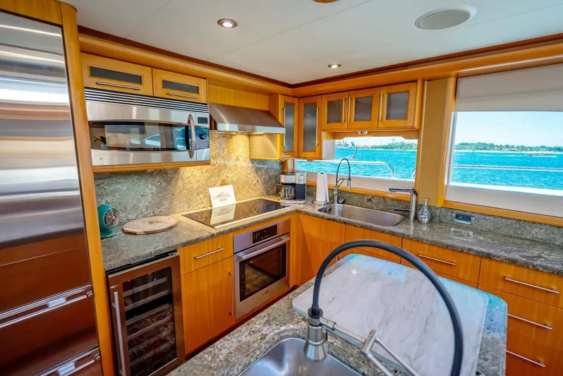 Serenity Yacht Photos Pics Luxurious kitchen in 2008 Lazzara Motor Yacht with ocean view, stainless steel appliances, and granite countertops.