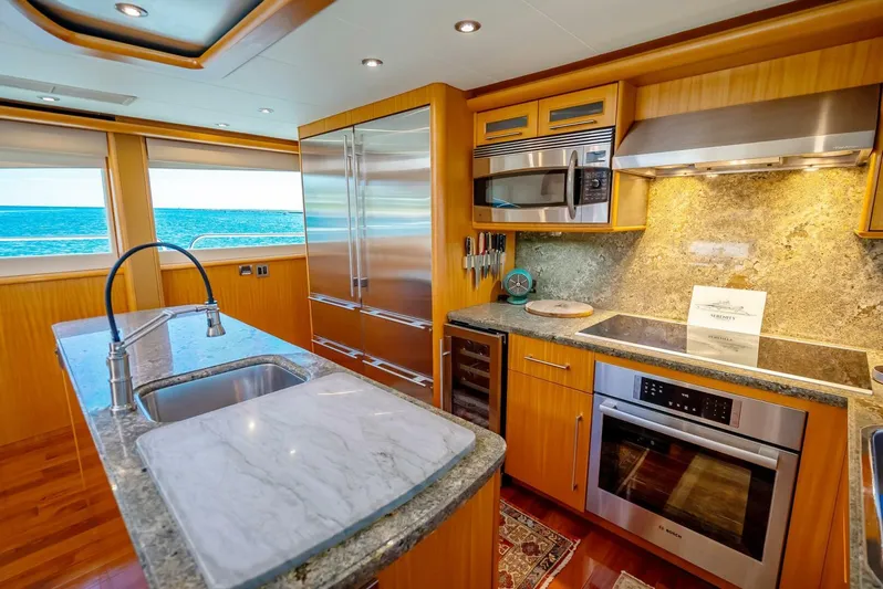 Serenity Yacht Photos Pics Luxurious kitchen in 2008 Lazzara Motor Yacht with ocean view, stainless steel appliances, and marble countertops.