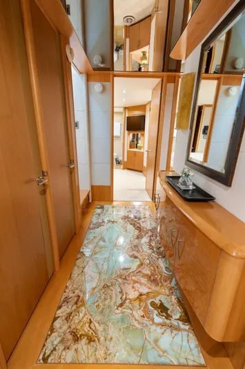 Serenity Yacht Photos Pics Luxurious interior hallway of 2008 Lazzara Motor Yacht with elegant wood finishes and marble flooring.