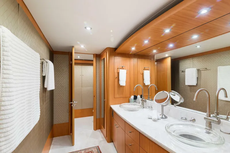 Serenity Yacht Photos Pics Luxurious bathroom in 2008 Lazzara Motor Yacht with double sinks and wooden cabinetry.