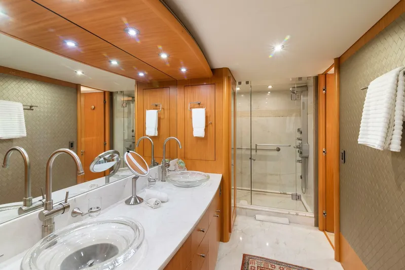 Serenity Yacht Photos Pics Luxurious bathroom in a 2008 Lazzara Motor Yacht with modern fixtures and glass shower.