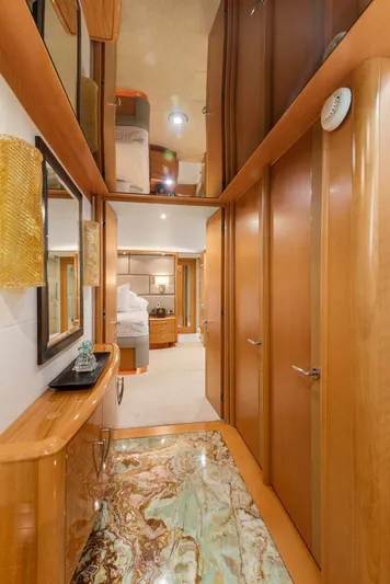 Serenity Yacht Photos Pics Luxurious hallway inside a 2008 Lazzara Motor Yacht with elegant wood finishes.