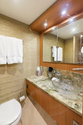 Serenity Yacht Photos Pics Luxurious bathroom in a 2008 Lazzara Motor Yacht with marble countertop and modern fixtures.