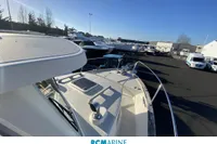 2008 Rhea RHEA 800 boat displayed at a marina under clear blue skies.