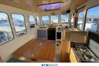 Interior of 2008 Rhea RHEA 800 boat with dining area and navigation equipment.