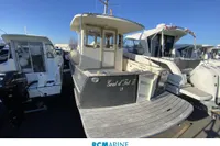 Rhea 800 boat from 2008 docked among other vessels at a marina.