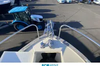Bow view of 2008 Rhea 800 boat with tractor in marina.