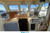 Interior view of 2008 Rhea RHEA 800 boat cockpit with control panel and steering wheel.