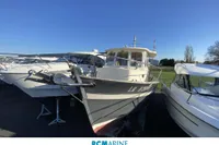 2008 Rhea 800 boat displayed outdoors under clear blue sky.