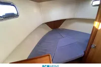 Cozy cabin interior of 2008 Rhea RHEA 800 boat with blue cushions.