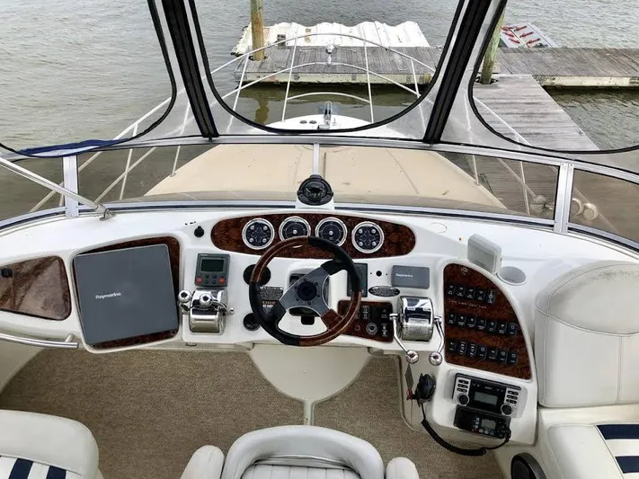  Yacht Photos Pics 2005 Meridian 459 Motoryacht helm with steering wheel, controls, and navigation equipment.