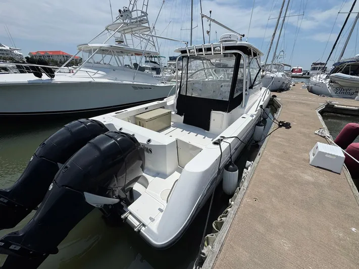 Bilboat Baggins Yacht Photos Pics 2011 Boston Whaler 305 Conquest docked, featuring dual outboard engines.