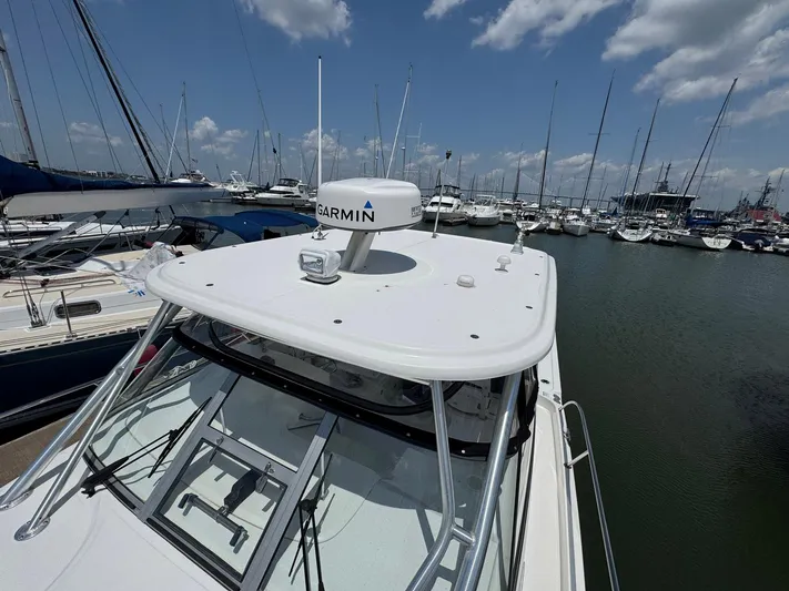 Bilboat Baggins Yacht Photos Pics 2011 Boston Whaler 305 Conquest docked at marina, featuring Garmin radar.