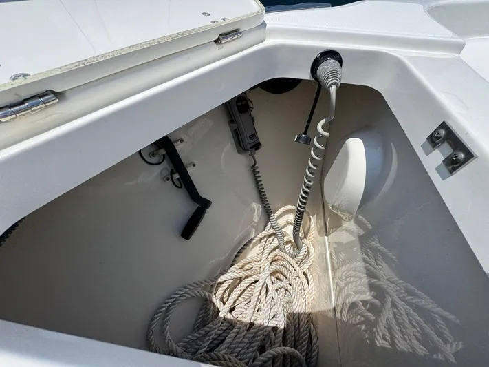 Bilboat Baggins Yacht Photos Pics Storage compartment of a 2011 Boston Whaler 305 Conquest with coiled ropes and equipment.