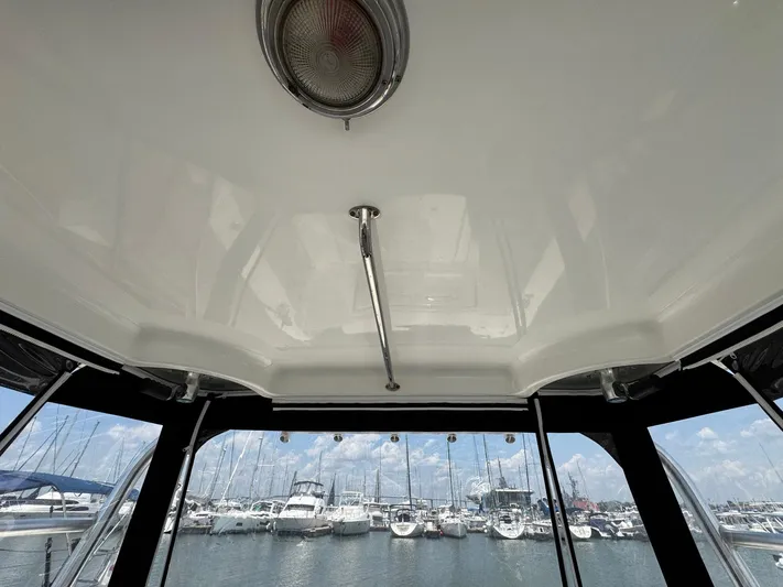 Bilboat Baggins Yacht Photos Pics Interior view of 2011 Boston Whaler 305 Conquest boat with marina in background.