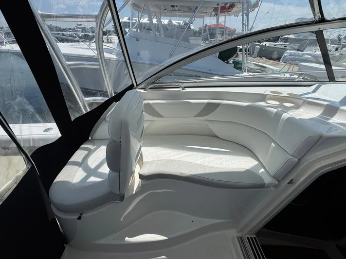 Bilboat Baggins Yacht Photos Pics 2011 Boston Whaler 305 Conquest interior with white seating and clear canopy.
