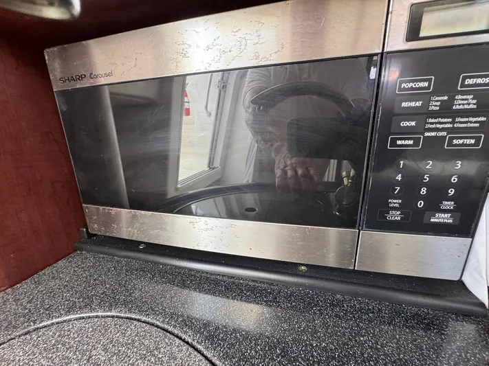 Bilboat Baggins Yacht Photos Pics Sharp Carousel microwave inside a 2011 Boston Whaler 305 Conquest boat kitchen.