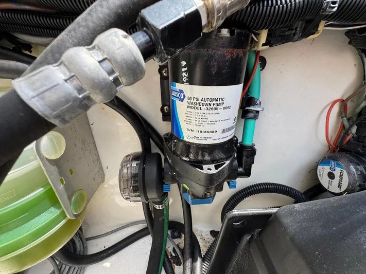 Bilboat Baggins Yacht Photos Pics 2011 Boston Whaler 305 Conquest engine compartment with Jabsco water pump and wiring.