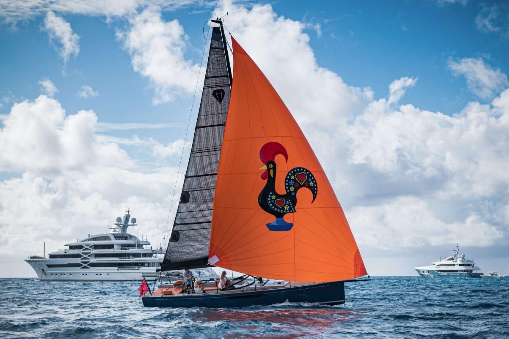 Saffier SE 33 Life sailboat with vibrant orange sail and rooster design, 2026 model.