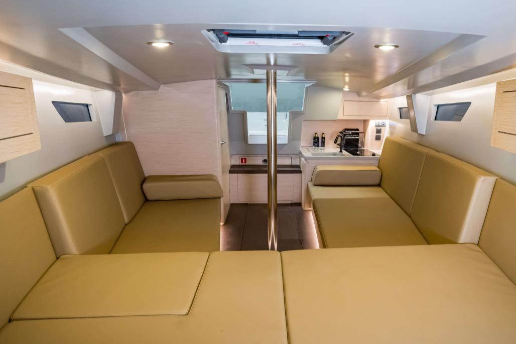 Luxurious interior of 2026 Saffier SE 33 Life yacht with beige seating and modern kitchen.