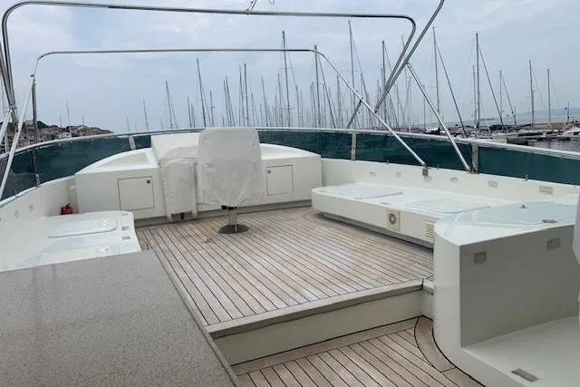  Yacht Photos Pics Spacious deck of 2012 Huzur Yachts 78 with elegant wood finish and marina view.