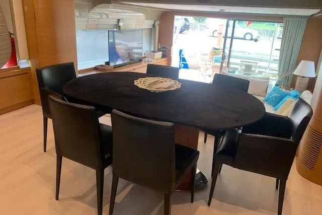  Yacht Photos Pics Luxurious dining area inside 2012 Huzur Yachts 78, featuring elegant black chairs and table.