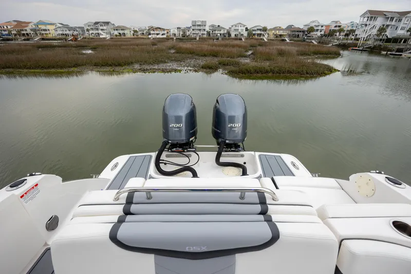  Yacht Photos Pics 2023 Chaparral 280 OSX boat with dual engines, overlooking a serene waterfront view.