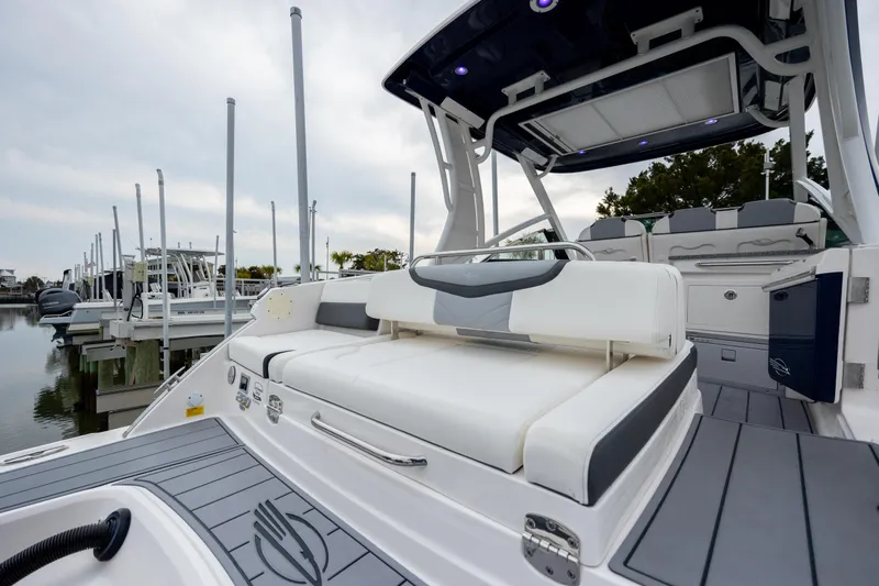  Yacht Photos Pics 2023 Chaparral 280 OSX boat with sleek seating and modern design at a marina.
