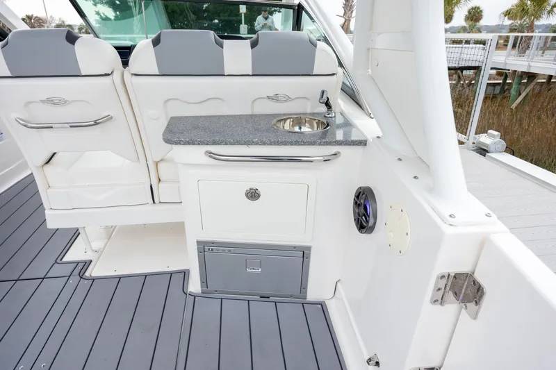  Yacht Photos Pics 2023 Chaparral 280 OSX boat interior with seating, sink, and storage on deck.