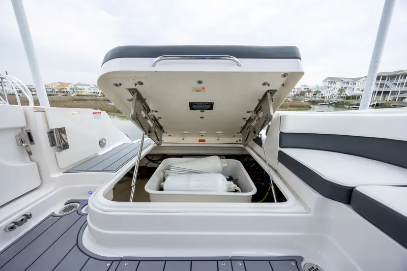  Yacht Photos Pics 2023 Chaparral 280 OSX boat storage compartment open, revealing interior space.