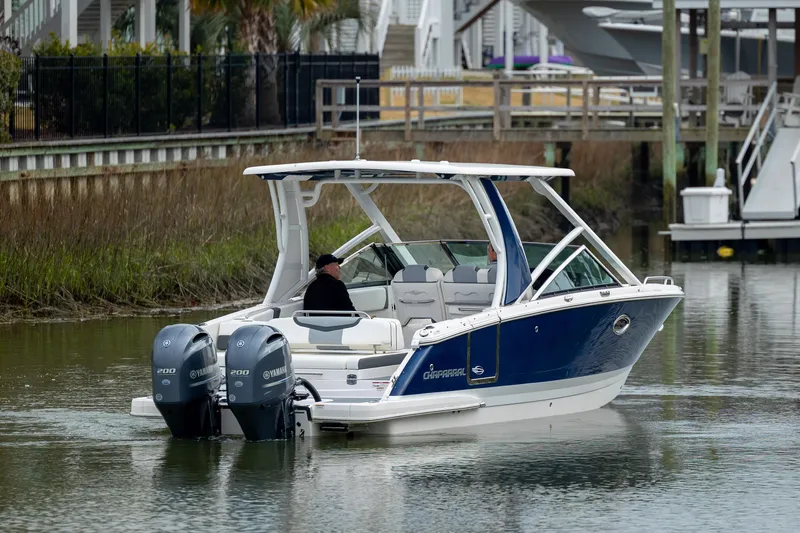  Yacht Photos Pics 2023 Chaparral 280 OSX boat with dual engines on a calm waterway.