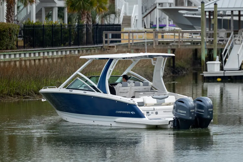  Yacht Photos Pics 2023 Chaparral 280 OSX boat cruising in a calm waterway.