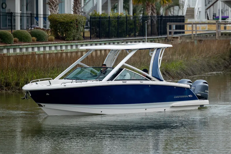  Yacht Photos Pics 2023 Chaparral 280 OSX boat cruising on a calm waterway.
