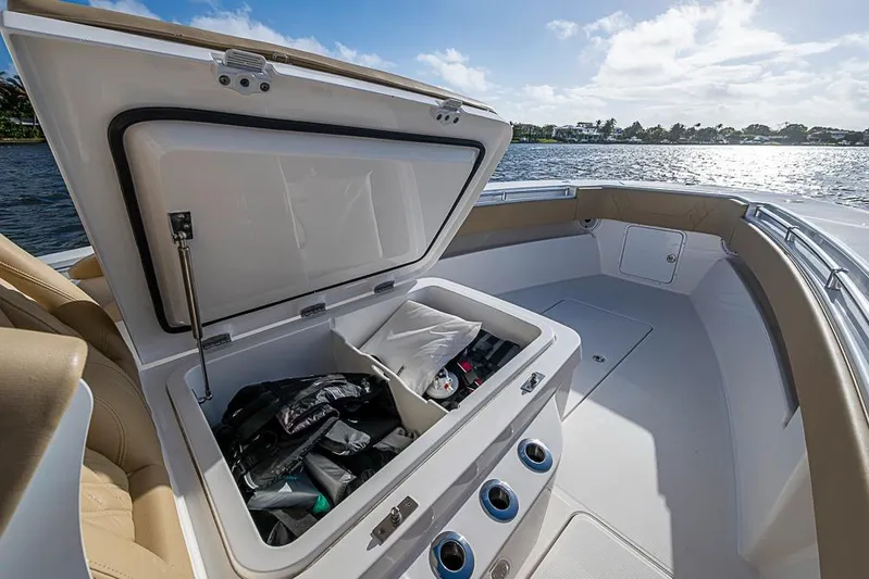 Rippleffect Yacht Photos Pics 2023 Invincible 33 Open Fisherman boat with open storage compartment, life jackets visible.