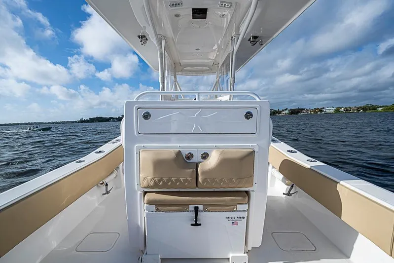 Rippleffect Yacht Photos Pics 2023 Invincible 33 Open Fisherman boat interior with tan seating, on a sunny day.