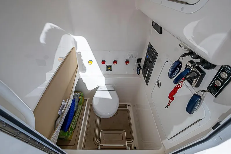 Rippleffect Yacht Photos Pics 2023 Invincible 33 Open Fisherman boat interior with toilet and control panel.