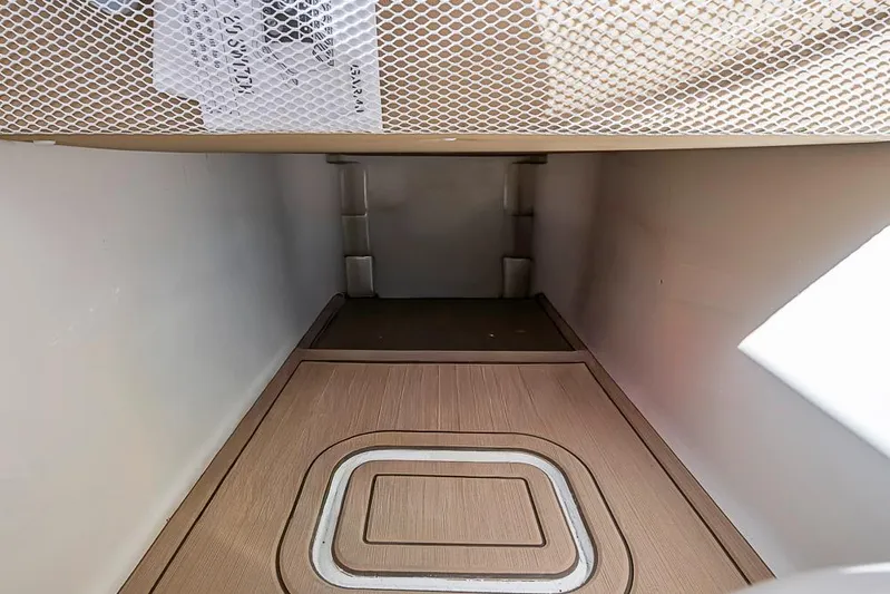 Rippleffect Yacht Photos Pics 2023 Invincible 33 Open Fisherman interior storage compartment with wooden flooring.