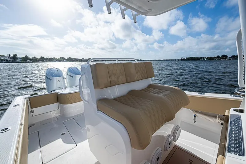 Rippleffect Yacht Photos Pics 2023 Invincible 33 Open Fisherman boat interior with twin outboard motors on a sunny day.