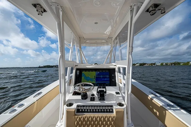 Rippleffect Yacht Photos Pics 2023 Invincible 33 Open Fisherman boat dashboard with navigation system on open water.