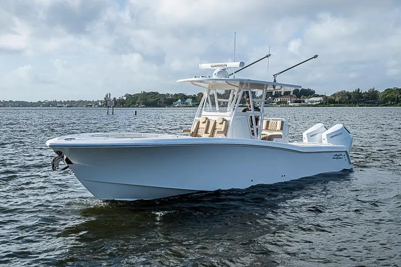 Rippleffect Yacht Photos Pics 2023 Invincible 33 Open Fisherman boat on calm water, featuring dual outboard engines.