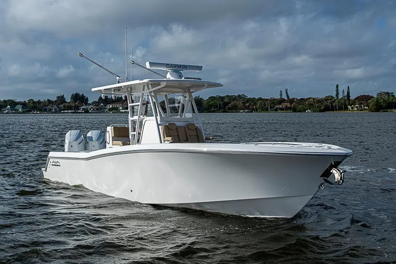 Rippleffect Yacht Photos Pics 2023 Invincible 33 Open Fisherman boat on water, featuring dual engines and sleek design.
