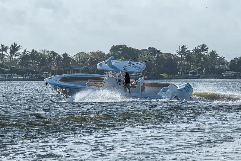 Rippleffect Yacht Photos Pics 2023 Invincible 33 Open Fisherman cruising on a scenic waterway.