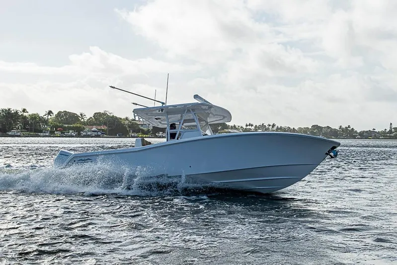 Rippleffect Yacht Photos Pics 2023 Invincible 33 Open Fisherman boat cruising on water, side view.